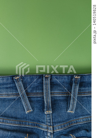 Closeup of denim jeans pocket on a solid background with space Closeup of denim jeans pocket on a solid background with space 140519828