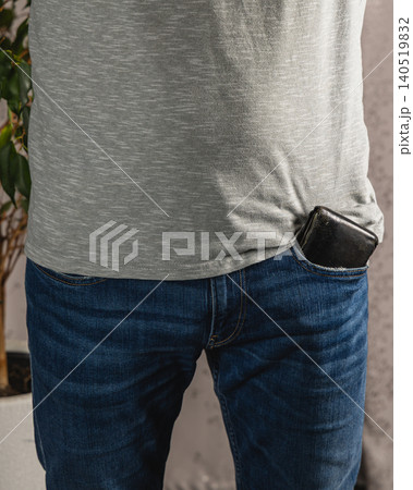 Casual outfit with wallet in jeans pocket and smartphone at home Casual outfit with wallet in jeans pocket and smartphone at home 140519832