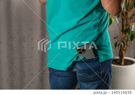 Casual look with smartphone in denim pocket alongside modern lifestyle choices Casual look with smartphone in denim pocket alongside modern lifestyle choices 140519838