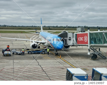 Cordoba, Argentina - April 20, 2026: Close view of an Aerolineas Argentinas aircraft at the boarding bridge. Cordoba, Argentina - April 20, 2026: Close view of an Aerolineas Argentinas aircraft at the boarding bridge. 140519997