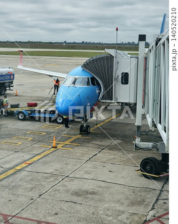 Cordoba, Argentina - April 20, 2026: Close view of a passenger aircraft through terminal windows at Taravella Airport. 140520210
