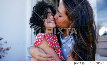 Mother kissing happy daughter on cheek showing love Mother kissing happy daughter on cheek showing love 140520523