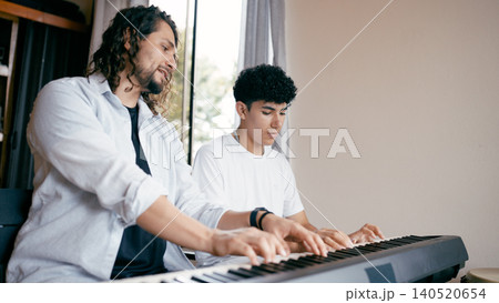Music teacher mentoring student during piano lesson Music teacher mentoring student during piano lesson 140520654