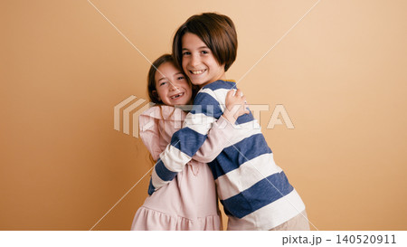 Children hugging smiling showing family love and joy Children hugging smiling showing family love and joy 140520911