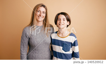 Mother and son smiling together for family portrait Mother and son smiling together for family portrait 140520912