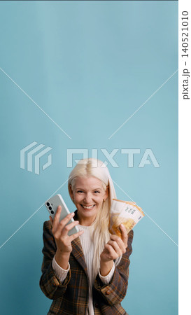 Woman celebrating online banking success with money Woman celebrating online banking success with money 140521010