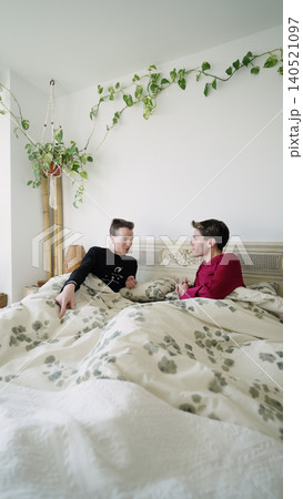 Gay couple having morning conversation in bed Gay couple having morning conversation in bed 140521097
