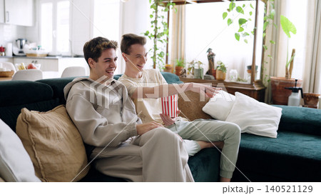 Happy young men enjoying movie night at home Happy young men enjoying movie night at home 140521129