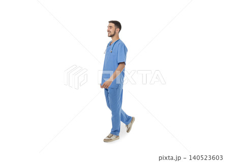 Doctor dressed in blue scrubs walking with confidence, on white Doctor dressed in blue scrubs walking with confidence, on white 140523603