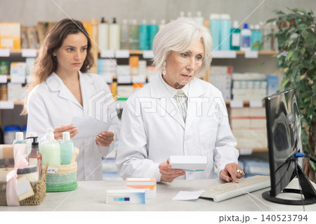 Two female pharmacists working in a pharmacy Two female pharmacists working in a pharmacy 140523794
