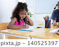 girl is studying and doing her homework in the classroom. 140525397