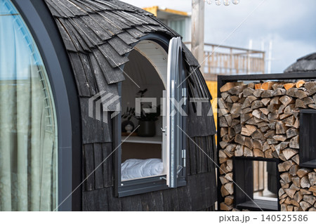 Modern Glamping Pod with Wooden Shingles and Open Window for Luxury Outdoor Travel Vacation Modern Glamping Pod with Wooden Shingles and Open Window for Luxury Outdoor Travel Vacation 140525586