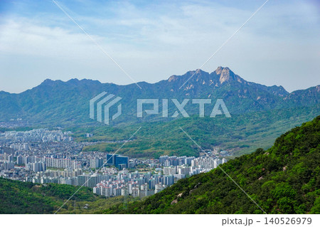 Panoramic view of Seoul cityscape surrounded by green mountains and Bukhansan ridge Panoramic view of Seoul cityscape surrounded by green mountains and Bukhansan ridge 140526979