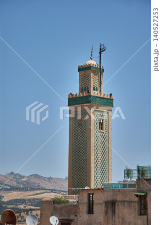 The minaret of the Great Mosque of Fes el-Jdid displays its traditional green tiles under the Moroccan sky The minaret of the Great Mosque of Fes el-Jdid displays its traditional green tiles under the Moroccan sky 140527253