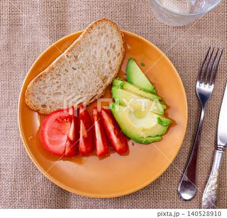 Fresh sliced avocado and tomato arranged on plate Fresh sliced avocado and tomato arranged on plate 140528910