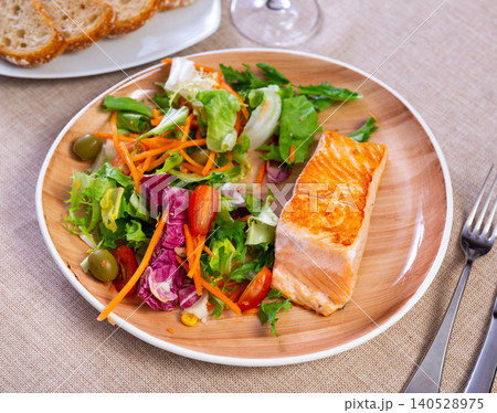 Salmon fillet with vegetables on a ceramic plate Salmon fillet with vegetables on a ceramic plate 140528975