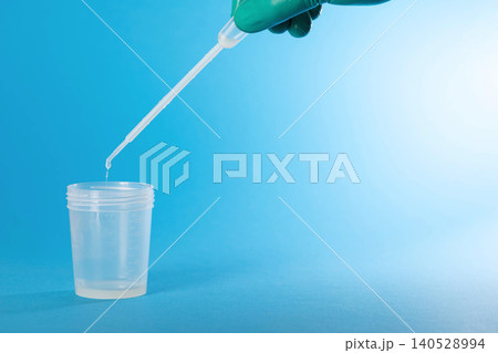 The doctor's hand collects ejaculate and prostate fluid for microscopic examination and leukocyte detection. Detection of infections by PCR. Copy space for text 140528994