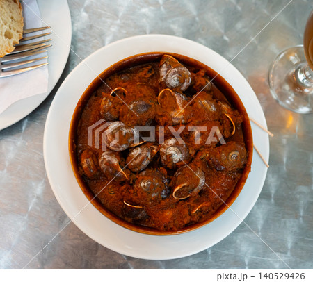Delicious baked snails in bowl with salsa sauce 140529426