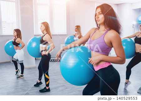 Young fitness women with blue fitballs. Crossfit training. Young fitness women with blue fitballs. Crossfit training. 140529553