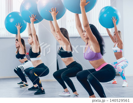 Young fitness women with blue fitballs. Crossfit training. Young fitness women with blue fitballs. Crossfit training. 140529561
