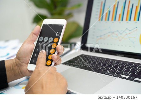 Asian accountant working and analyzing financial reports project accounting with chart graph in modern office, finance and business. 140530167