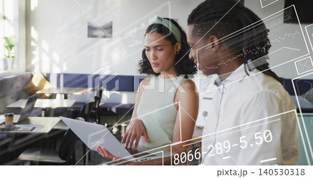 Holding laptop, two coworkers in sleeveless top and white shirt pointing at screen at cafe, AR Holding laptop, two coworkers in sleeveless top and white shirt pointing at screen at cafe, AR 140530318