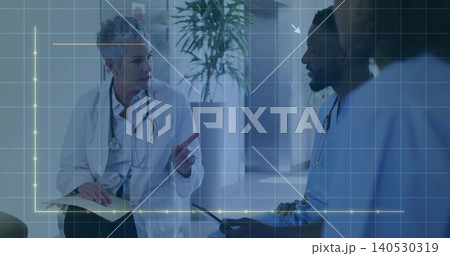 Discussing doctor in white coat pointing and holding notebook in clinic with tablet, graph overlay Discussing doctor in white coat pointing and holding notebook in clinic with tablet, graph overlay 140530319