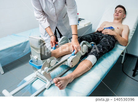 Patient on CPM (continuous passive range of motion) machines. Patient on CPM (continuous passive range of motion) machines. 140530396