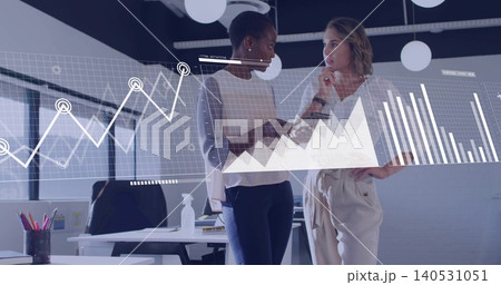 Discussing business casual women pointing at tablet, analyzing charts in office, laptop sanitizer Discussing business casual women pointing at tablet, analyzing charts in office, laptop sanitizer 140531051