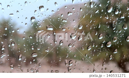 Raindrops on window with blurred garden and house beyond Raindrops on window with blurred garden and house beyond 140531271