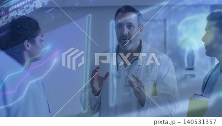 Gesturing mature physician discussing in clinic corridor with white coats stethoscopes clipboard AR 140531357