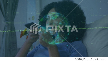 Holding phone woman wearing light blue top speaking while reclining on couch at home, with hologram Holding phone woman wearing light blue top speaking while reclining on couch at home, with hologram 140531360