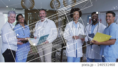 Standing team of six in reception wearing lab coats, scrubs, holding stethoscopes with tech overlay Standing team of six in reception wearing lab coats, scrubs, holding stethoscopes with tech overlay 140531460