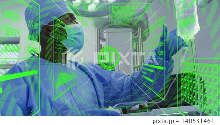 Manipulating green AR panels, male clinician adjusting IV bag inside ambulance bay in blue scrubs 140531461