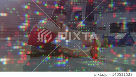 Stretching fit man reaching right foot on gym floor, wearing red top, headphones, pixel artifacts Stretching fit man reaching right foot on gym floor, wearing red top, headphones, pixel artifacts 140531528