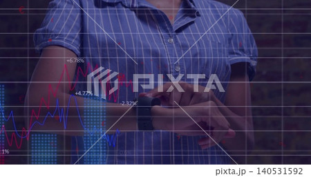 Tapping woman wearing blue striped shirt using smartwatch amid overlaid data charts, brick wall Tapping woman wearing blue striped shirt using smartwatch amid overlaid data charts, brick wall 140531592