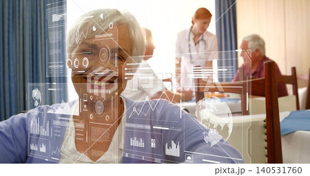Smiling senior facing lens in dining room, nurse, white-coat with stethoscope, leaning over men HUD 140531760