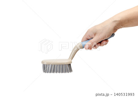 Woman holding a plastic brush on the white background. Woman holding a plastic brush on the white background. 140531993