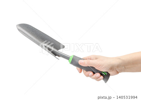 Small garden trowel in a hand on the white isolated background Small garden trowel in a hand on the white isolated background 140531994