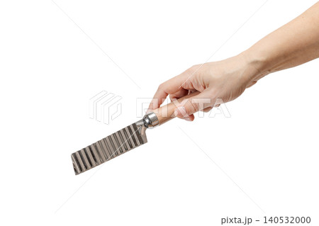 Woman's hand holding a cheese and potato knife on the white background. 140532000