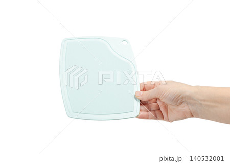 Plastic cutting board in the woman's hand on the white background Plastic cutting board in the woman's hand on the white background 140532001