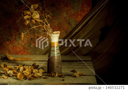 still life dried flowers in old vase on wood background 140532271