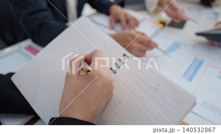 Business person taking notes during office meeting Business person taking notes during office meeting 140532867