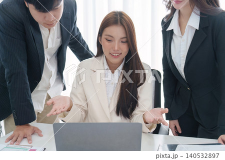 Asian business team collaborating on laptop in modern office meeting 140532897