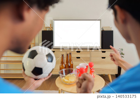 Asian and Southeast Asian men watching football game on blank TV screen 140533175
