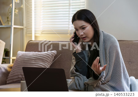 Asian woman on phone call with laptop for telehealth consultation Asian woman on phone call with laptop for telehealth consultation 140533223