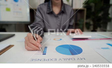 Asian woman analyzing daily expenses and budget with calculator 140533558