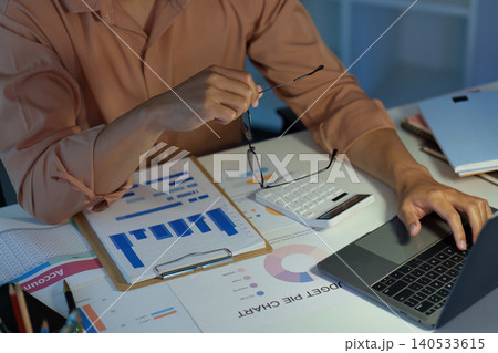 Asian man analyzing finance data and budget planning at remote home office Asian man analyzing finance data and budget planning at remote home office 140533615