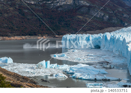 Perito Moreno glaciers, icy cliff over lake with mountain backdrop and floating ice in cold calm landscape 140533751
