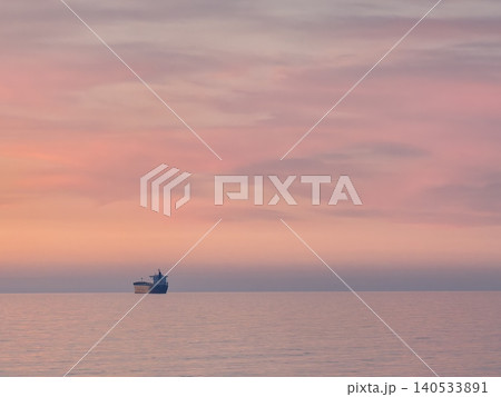 Ship silhouette on calm sea at sunset Ship silhouette on calm sea at sunset 140533891